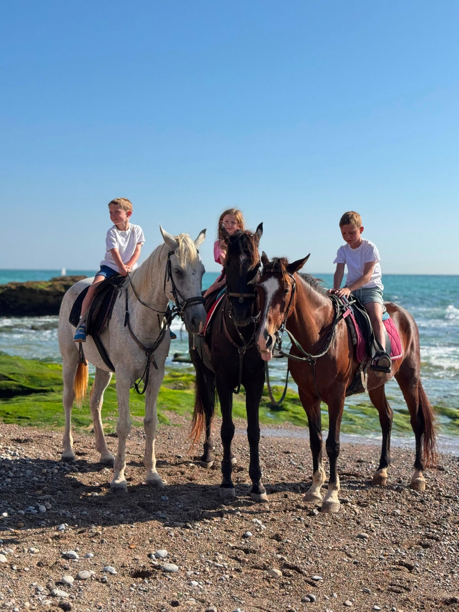Family horse riding in Agadir, Morocco — three children on horseback at Ranch Banana